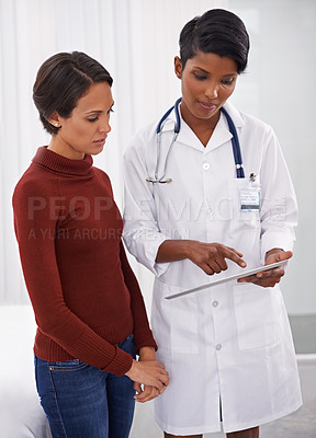 Buy stock photo Tablet, healthcare and patient with doctor in hospital for consultation on diagnosis or treatment. Discussion, research and woman with female medical worker reading on digital technology in clinic.