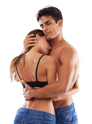 Buy stock photo Studio shot of a woman in a black bra being embraced by her boyfriend