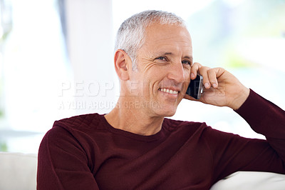 Buy stock photo A mature man having an amusing phone conversation