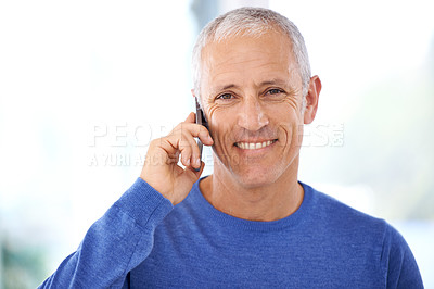 Buy stock photo A mature man having a pleasant phone conversation