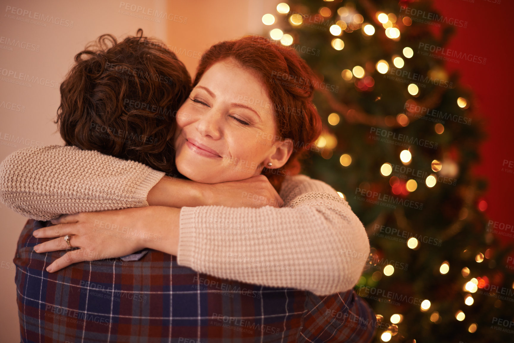 Buy stock photo Couple, Christmas and hug for holiday celebration, festive season of giving for love and commitment. Happiness, gratitude and support with people at home, romance and relationship with peace together