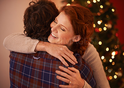 Buy stock photo Cropped shot of an affectionate young couple embracing at Christmas