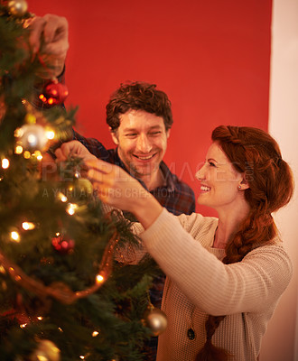 Buy stock photo Couple, tree and christmas with smile, decoration and celebration for holiday spirit. Man, woman and love with happy marriage, relationship and romance with ornament for vacation break and care
