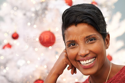 Buy stock photo Portrait of a beautiful young woman beside a Christmas tree