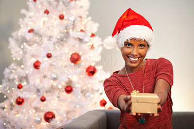 Buy stock photo Smile, santa hat and portrait of woman with present at her home for christmas event, party or celebration. Happy, holidays and face of female person with festive xmas tree and gift on sofa at house.
