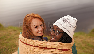 Buy stock photo Camping, blanket and portrait of women by lake in nature on outdoor holiday, vacation and adventure, Campsite, travel and friends hug and bonding in woods, forest and countryside together in winter