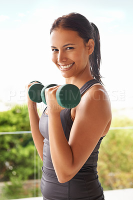 Buy stock photo Portrait, dumbbell and happy woman outdoor for training, exercise and workout for power. Face, muscle and strong person weightlifting for fitness, sports and healthy body for wellness at balcony