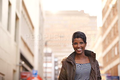 Buy stock photo A cropped portrait of a beautiful young woman in the city