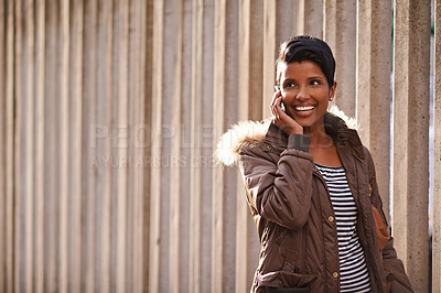 Buy stock photo Woman, smile and cellphone for call, discussion and communication with winter jacket. Reporter, technology and happiness for conversation, collaboration and concrete wall for walk and urban city