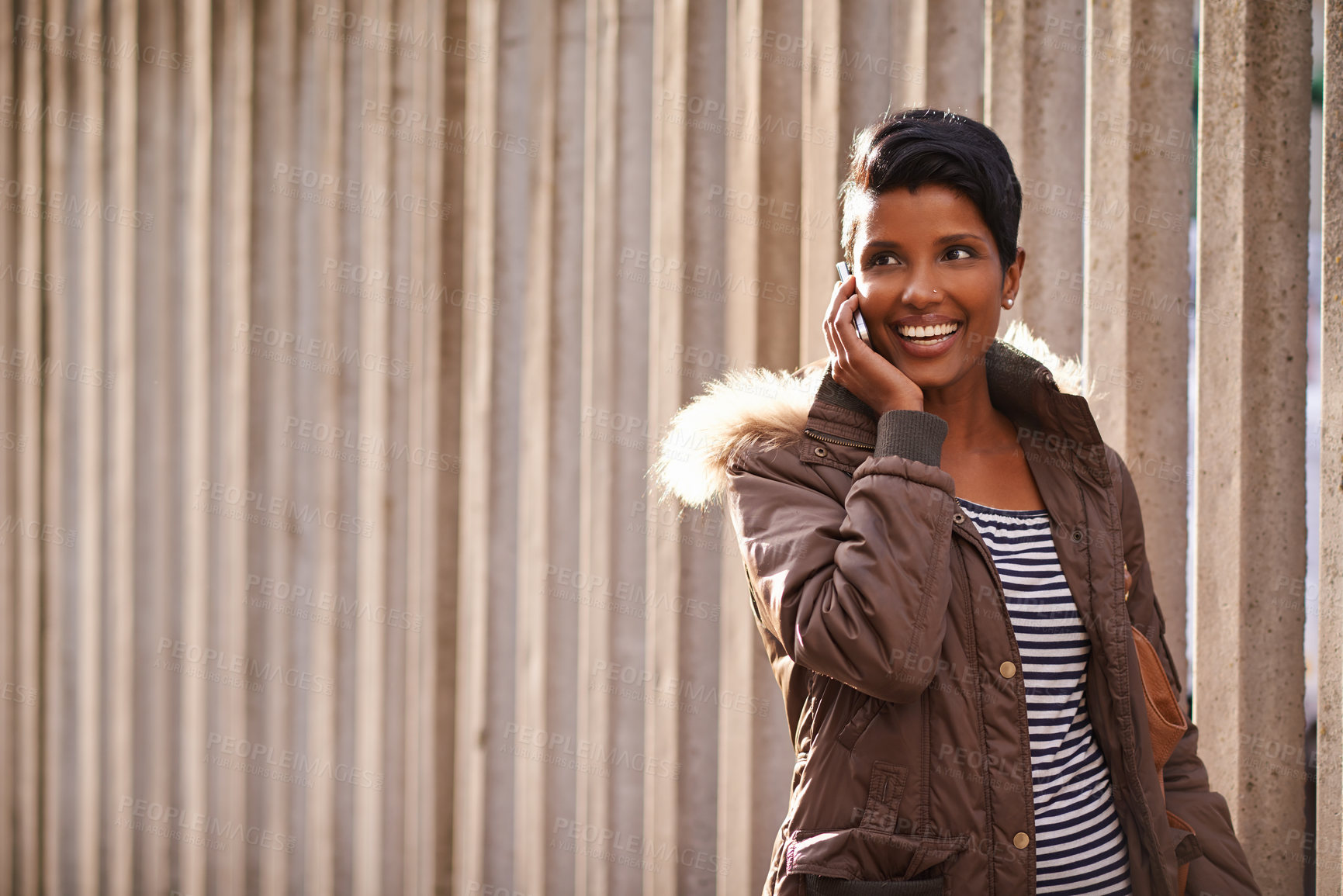 Buy stock photo Woman, smile and cellphone for call, discussion and communication with winter jacket. Reporter, technology and happiness for conversation, collaboration and concrete wall for walk and urban city