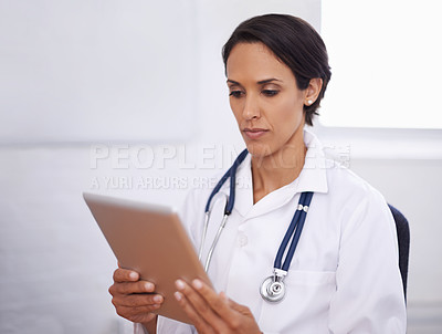 Buy stock photo Shot of a young doctor using a digital tablet