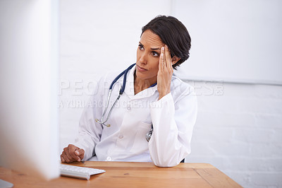 Buy stock photo Portrait of a young female doctor working at her computer