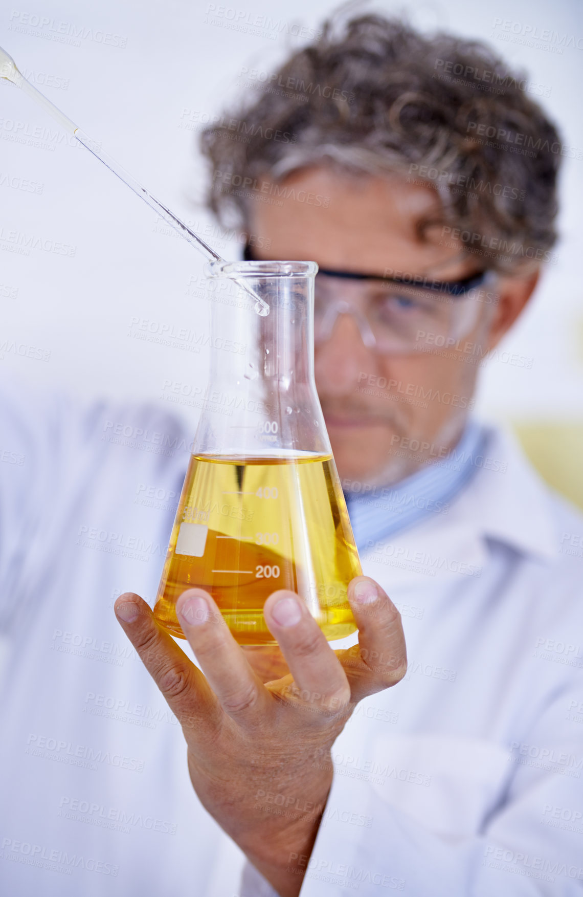 Buy stock photo Science, laboratory and man with liquid in beaker for medical research, analysis and vaccine development. Healthcare, pharmaceutical and scientist with glass test tube for sample, experiment or study