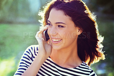Buy stock photo Shot of a gorgeous young woman on the phone while outside