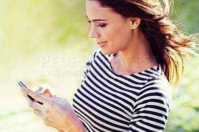 Buy stock photo Woman, cellphone or social media for update in park, nature or search for travel app to download. Young person, smartphone or browse internet for networking or reading message on connection in field