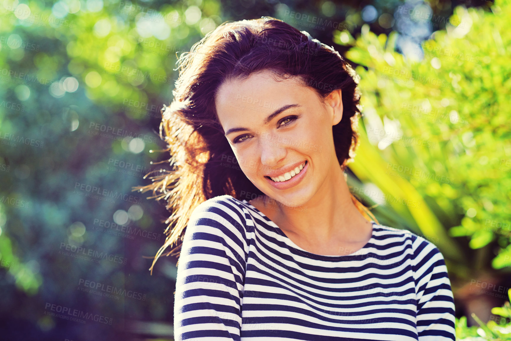 Buy stock photo Portrait of a gorgeous young woman standing in the sunlight outdoors