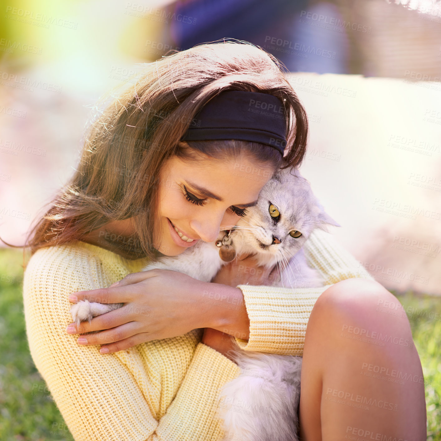 Buy stock photo Trendy young woman with Persian cat cuddling and loving her grey feline while sitting on the grass outside at park. 
 Beautiful lady in retro style fashion snuggling her adorable pet with soft fur