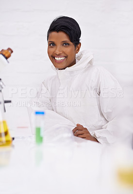 Buy stock photo A portrait of a happy young scientist sitting in her lab