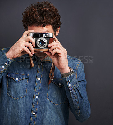 Buy stock photo Vintage, fashion or photography by man, camera lens or capture of creative, graphic or style. Male photographer, film or retro gadget as trendy, denim or urban outfit in studio on grey background