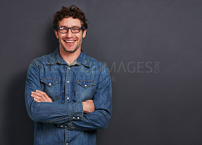 Buy stock photo Studio, portrait and man with smile, glasses and casual fashion on mockup space for creative professional. Relax, happy and person with confidence, pride and trendy denim style on dark background