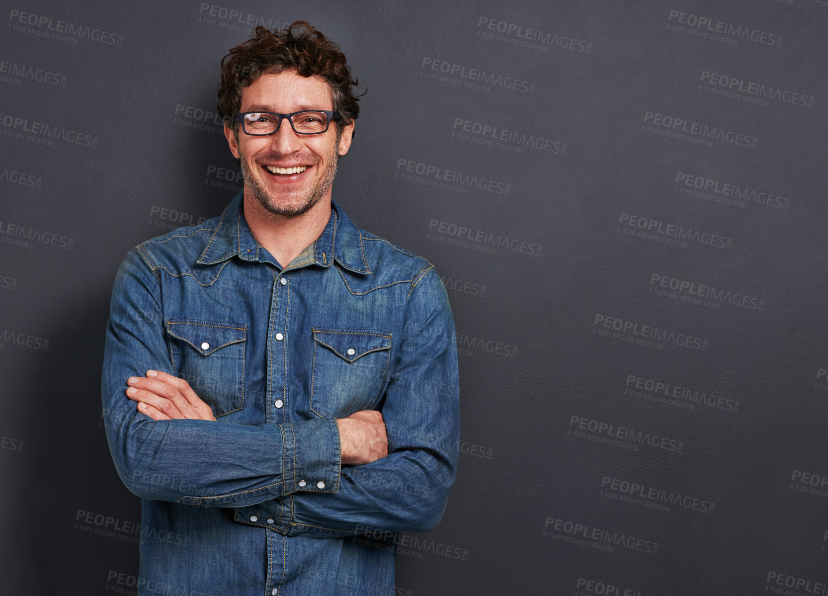 Buy stock photo Studio, portrait and man with smile, glasses and casual fashion on mockup space for creative professional. Relax, happy and person with confidence, pride and trendy denim style on dark background