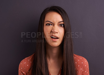 Buy stock photo Studio shot of an attractive young woman with a comically confused expression