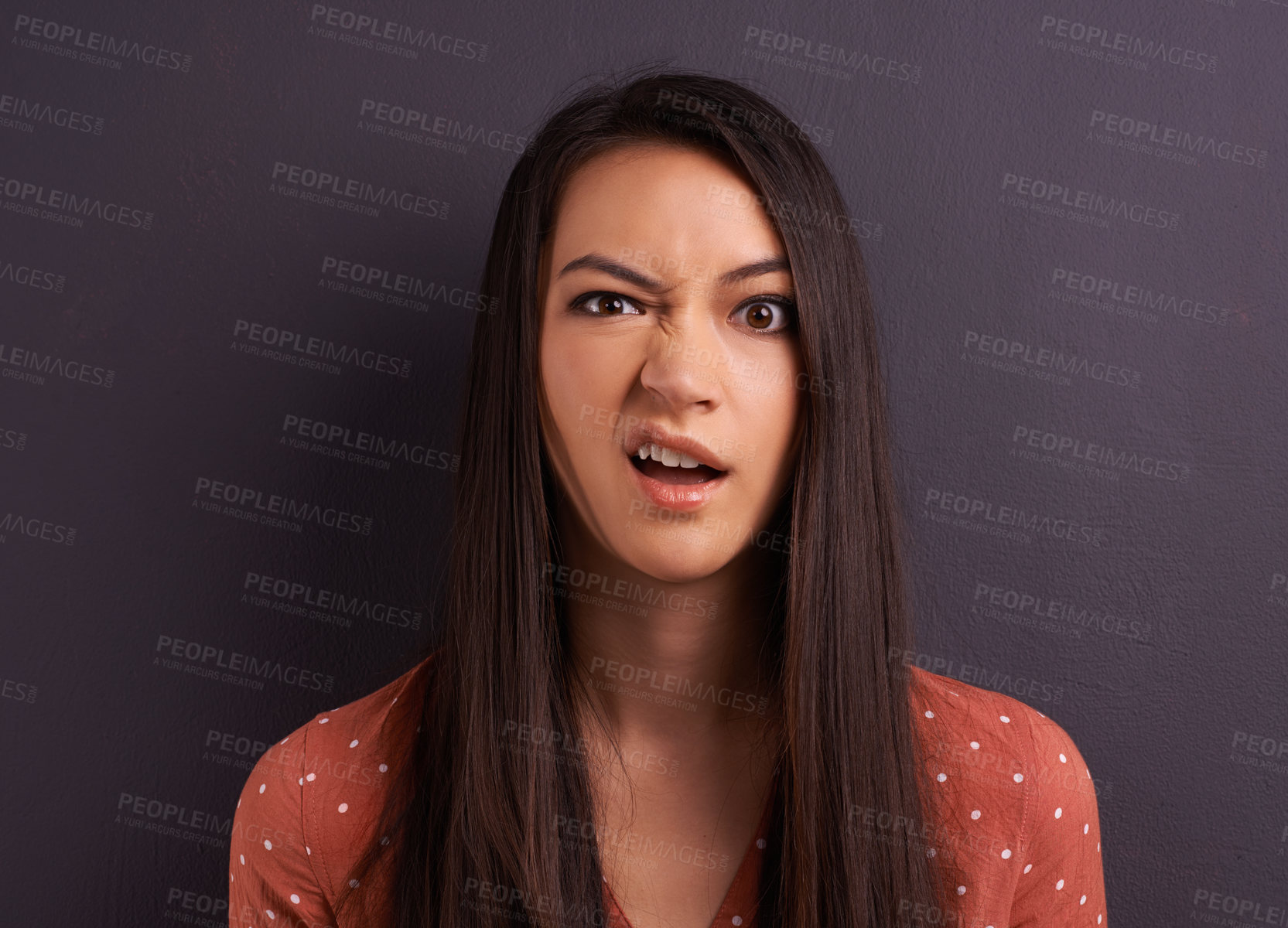 Buy stock photo Studio shot of an attractive young woman with a comically confused expression