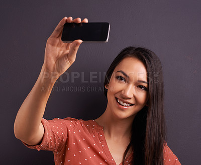 Buy stock photo Woman, selfie and social media post for online connection on studio for profile picture, technology or grey background. Female person, smile and internet communication or streaming, vlog or mockup