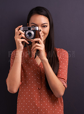 Buy stock photo Happy woman, portrait and photography with camera for memory or picture on a dark studio background. Young female person or creative journalist with smile for photo, moment or capture for startup
