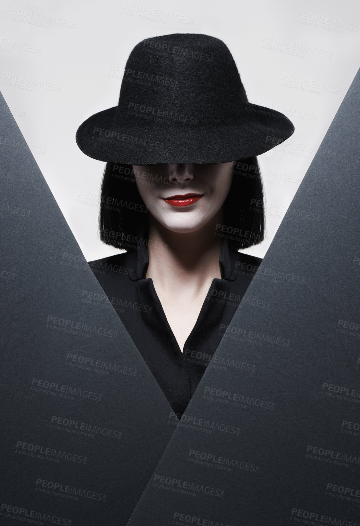 Buy stock photo Studio shot of a mysterious woman wearing a hat against a gray background