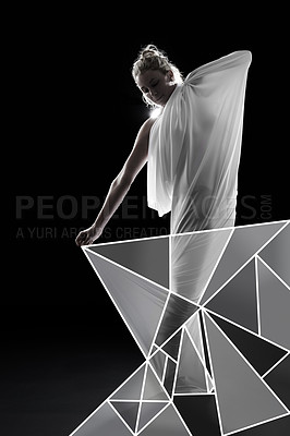 Buy stock photo Studio shot of a woman wrapped in fabric and surrounded by geometric shapes against a black background