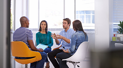 Buy stock photo Shot of a young group of designers having a discussion