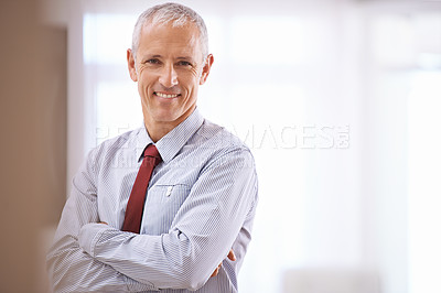 Buy stock photo Portrait of a happy mature business man with his arms folded