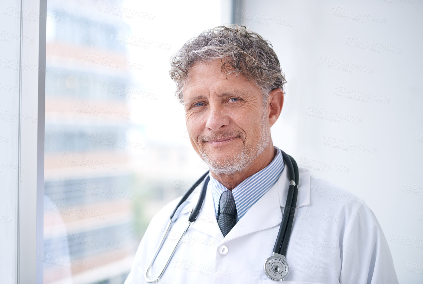 Buy stock photo Senior man, doctor and smile portrait in office for healthcare, medical support and medicine career with stethoscope. Mature, face and health expert with confidence and happy for cardiology in clinic