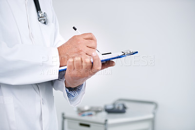 Buy stock photo Cropped shot of a doctor standing in his office and holding a clipboard