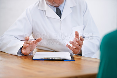 Buy stock photo Cropped shot of a doctor explaining something to his patient