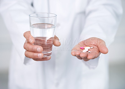 Buy stock photo Medicine, pills and water in hands of doctor in clinic or hospital to offer of healing healthcare. Medical, drugs or person giving pharmaceutical supplements to drink as cure for pain of sick patient