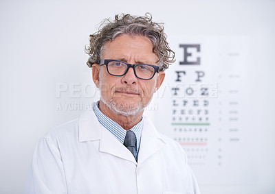 Buy stock photo Test, eye and portrait of optometrist in clinic with glasses to check vision and exam in healthcare. Mature, doctor and reading letters on wall in medical assessment for contact lenses or eyesight
