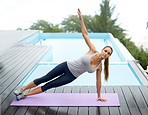Demonstrating the sidewards plank yoga pose