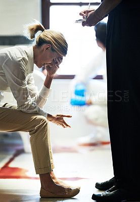 Buy stock photo Shot of a grief stricken woman giving her statement to a police officer at a crime scene