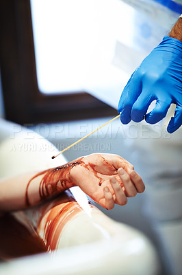 Buy stock photo Cropped shot of a gloved hand carrying out forensics testing on a bloody hand