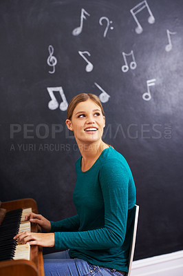 Buy stock photo Shot of a woman playing the piano against a background of musical notes