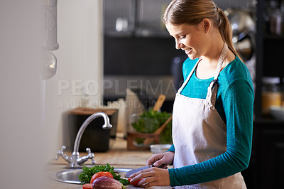 Buy stock photo Nutrition, cooking and woman with ingredients in kitchen cutting vegetables with knife at home. Happy, groceries and female person with organic produce for dinner, supper or meal at apartment.