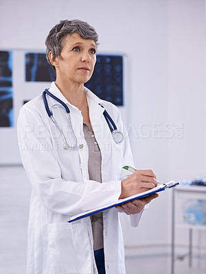 Buy stock photo Shot of a female doctor holding a clipboard