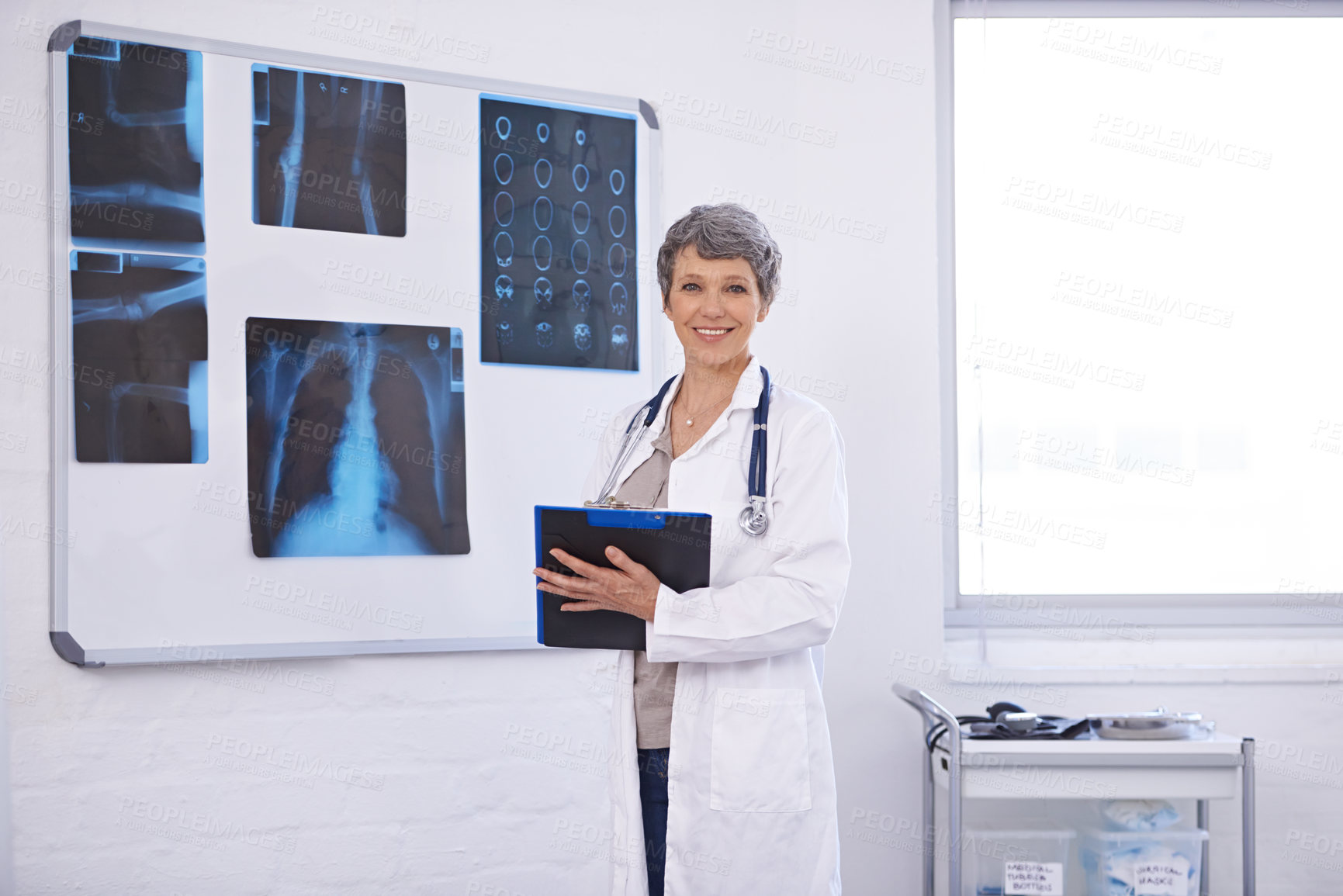 Buy stock photo Doctor, woman and clipboard in portrait, radiology for surgery with anatomy scan and healthcare. Senior medical professional, treatment and surgeon in room for xray, checklist and confident expert