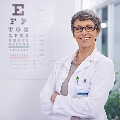 Buy stock photo Woman, senior optometrist and arms crossed for eye care in portrait, test and alphabet chart for vision. Glasses, prescription lens and frame for healthcare, confidence with ophthalmologist at clinic
