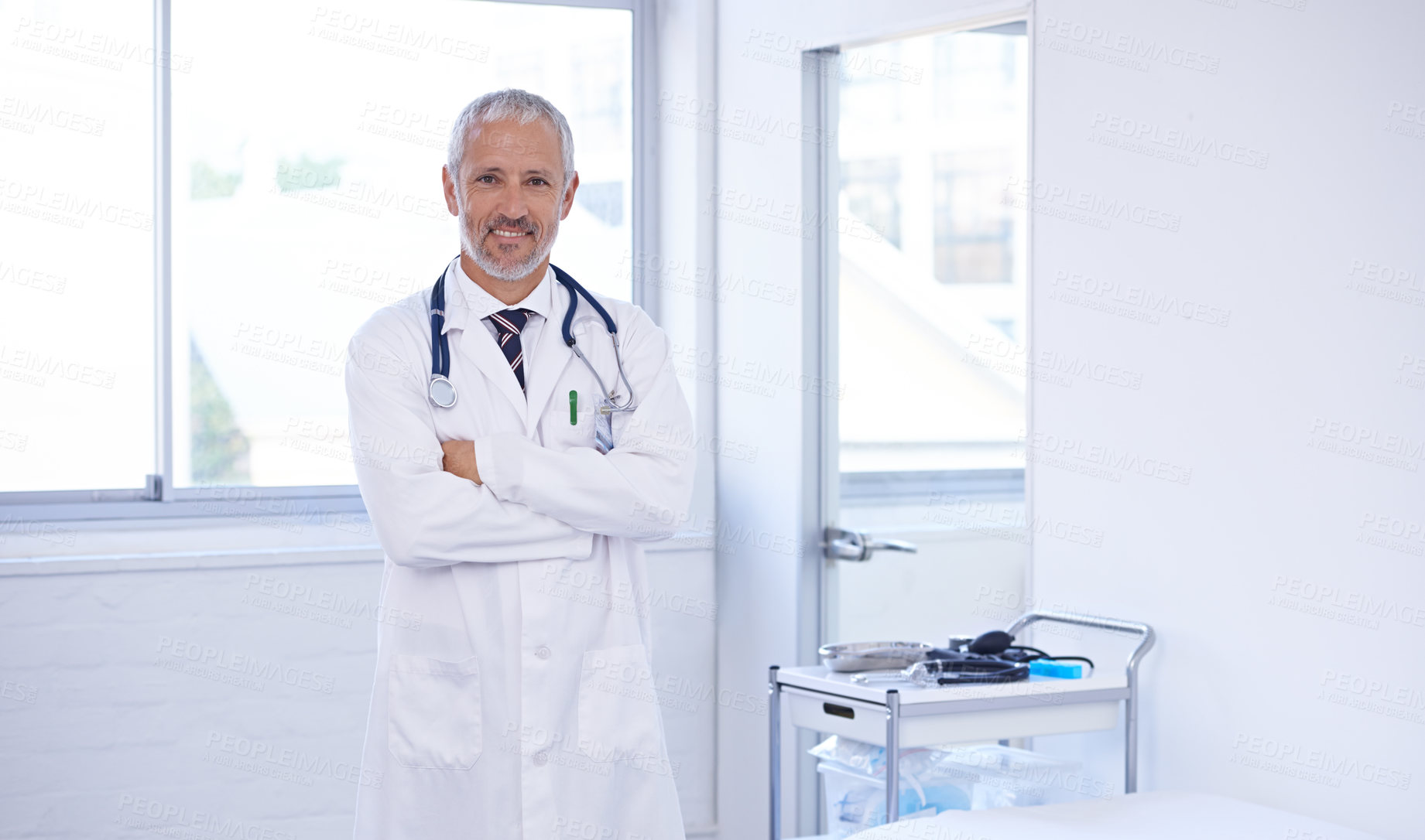 Buy stock photo Doctor, portrait and happy senior man with arms crossed in consultation for medical, advice or help at hospital room. Healthcare, face or male expert with career pride, smile or clinic consulting