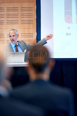 Buy stock photo Senior, businessman and boss with presentation on projector for meeting, seminar or conference at office. Man spokesperson, CEO or speaker talking on podium to group or corporate audience at workshop