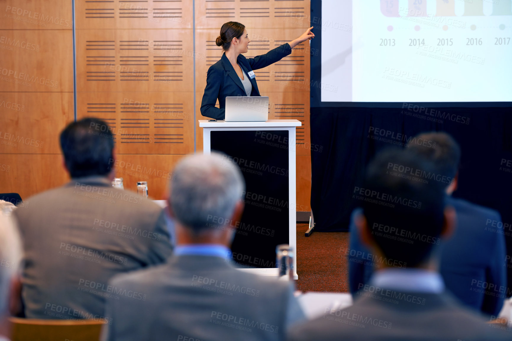 Buy stock photo Shot of a group of businesspeople watching a presentation at a conference