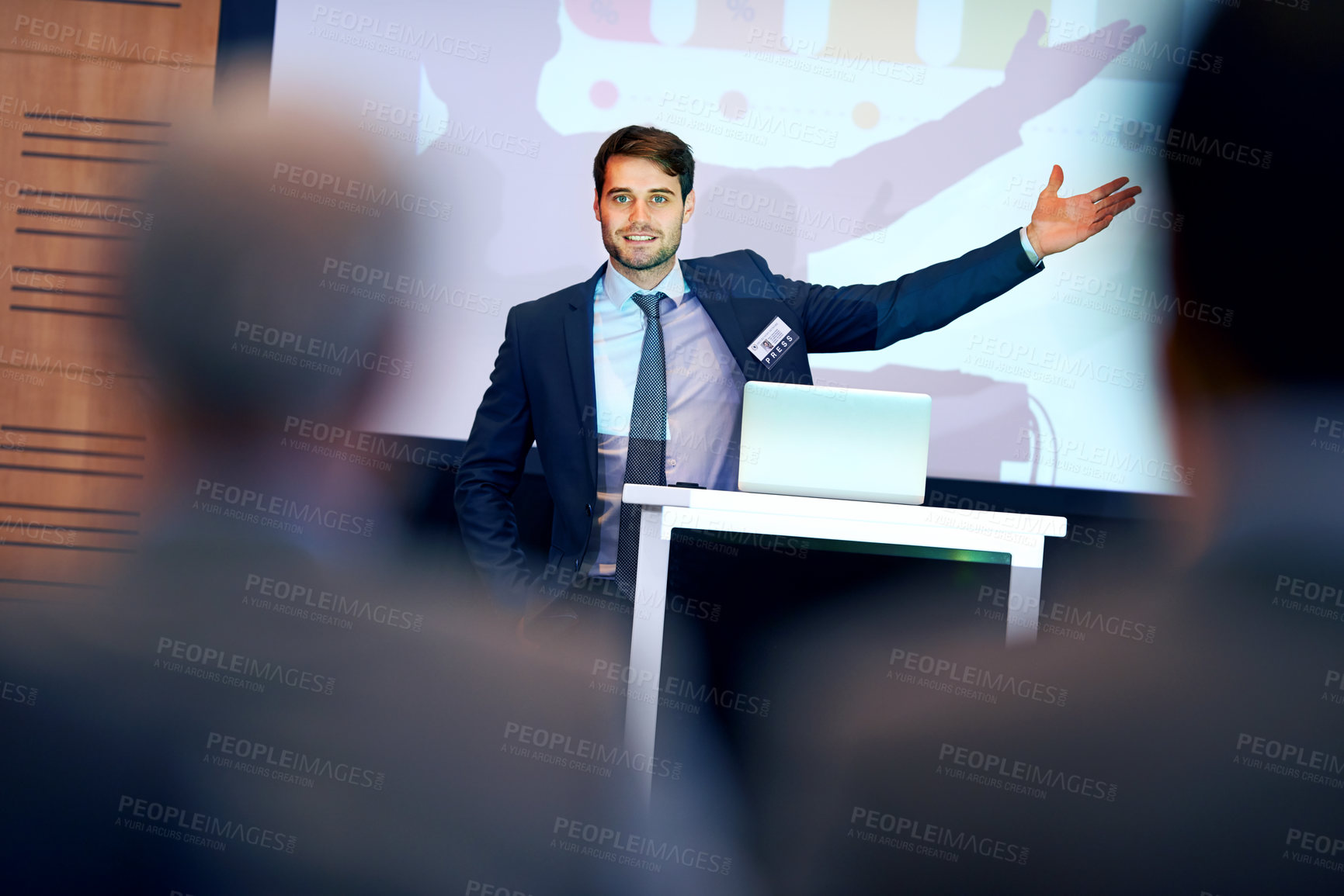 Buy stock photo A confident businessman gesturing while giving a presentation at a press conference